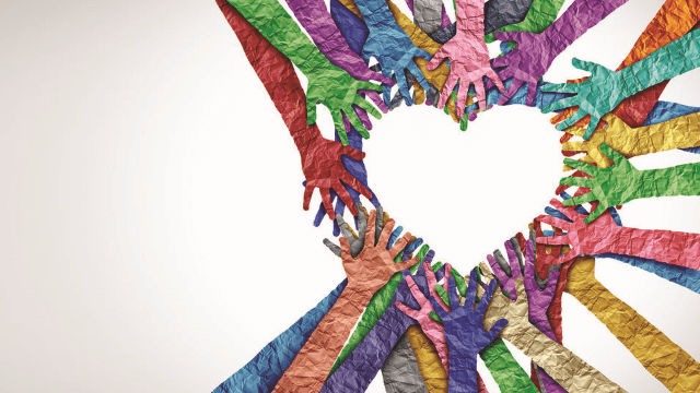 Multiple colorful, textured paper hands reach toward the center of the image, forming a heart shape against a light background—symbolizing unity, support, community, and Accessing Recovery through collective Recovery Supports.