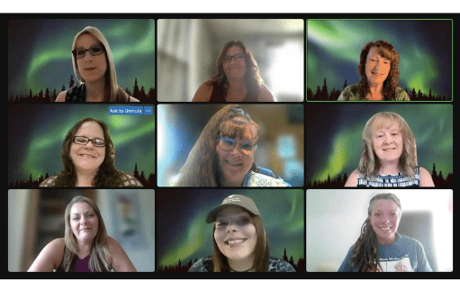 A virtual meeting with nine women smiling in individual video call boxes, each with a green aurora borealis background and a forest silhouette at the bottom, embodies the spirit of Power of Recovery and the supportive nature of Recovery Coaching.