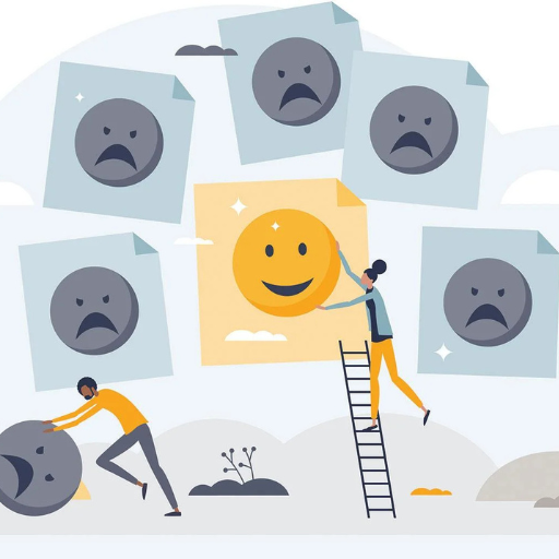 Two people work to position a large smiling face among surrounding sad faces on cards.