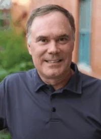 Portrait of Doug Dunbar, smiling, wearing a navy polo shirt.
