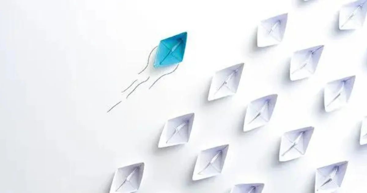 A blue paper plane breaking away from ordered rows of white paper planes.