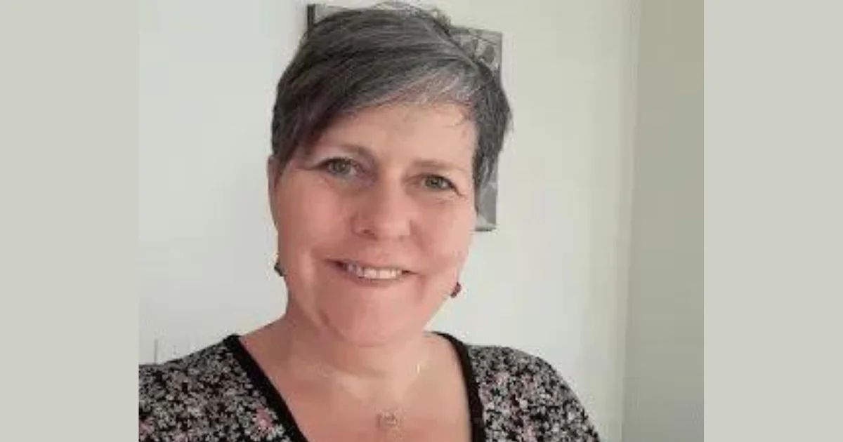 Portrait of Niki Curtis, smiling, in a patterned top.