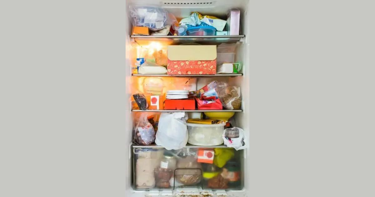 An open refrigerator stocked with food and containers.