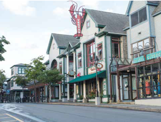A quiet Maine main street in early morning light, evoking the everyday places where recovery lives in plain sight.