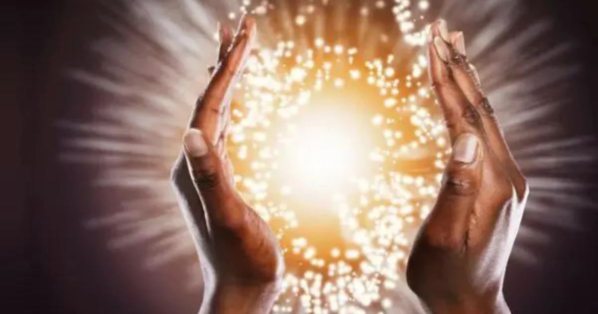 Cupped hands cradling a burst of golden light.
